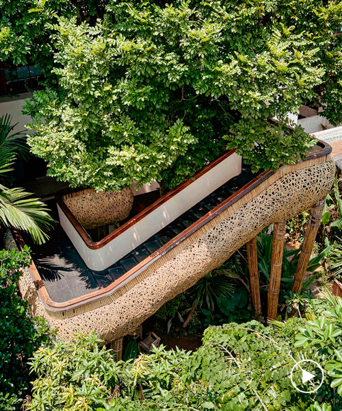 weaved bamboo wraps the floating promenades of spa and restaurant in china