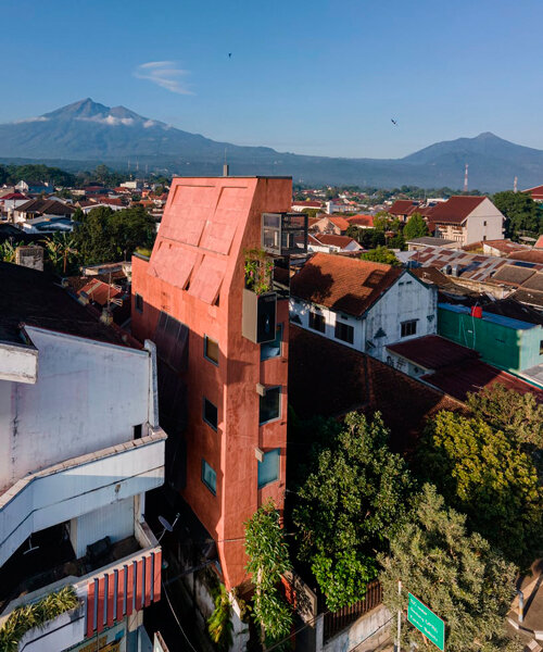 red agra sandstone coats the facades of slender PituRooms hotel in indonesia