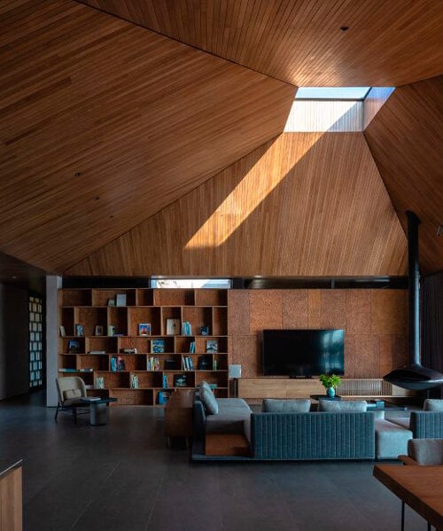 wooden pyramid skylight illuminates suoi hai villa's interior in vietnam